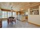 The dining area flows into a bright kitchen with wood ceiling and access to the backyard at 7890 W 43Rd Pl, Wheat Ridge, CO 80033
