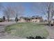 View of the home's exterior, showcasing a well-manicured lawn and circular driveway at 7890 W 43Rd Pl, Wheat Ridge, CO 80033