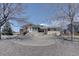 Charming single-Gathering home with a stone patio, wooden deck, and a large circular driveway at 7890 W 43Rd Pl, Wheat Ridge, CO 80033