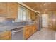 Galley kitchen featuring custom wood cabinets, granite countertops, and stainless appliances at 7890 W 43Rd Pl, Wheat Ridge, CO 80033
