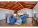 Large living room featuring vaulted ceilings, wood floors, and brick fireplace at 7890 W 43Rd Pl, Wheat Ridge, CO 80033