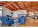 Cozy living room with vaulted ceilings, wood floors, and brick fireplace at 7890 W 43Rd Pl, Wheat Ridge, CO 80033