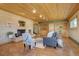 Comfortable living room with a painted brick fireplace, built-in shelves, and wood ceiling at 7890 W 43Rd Pl, Wheat Ridge, CO 80033