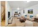 Finished basement with recreational area, comfortable seating, and neutral carpeting at 8137 Vanguard Dr, Denver, CO 80221
