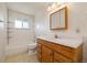 Bathroom with single sink vanity, medicine cabinet, and tub-shower combo at 8137 Vanguard Dr, Denver, CO 80221