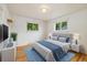 Bright bedroom with natural light, hardwood floors, and a calming blue accent rug at 8137 Vanguard Dr, Denver, CO 80221