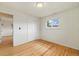 Bedroom with hardwood floors, closet and window with outdoor view at 8137 Vanguard Dr, Denver, CO 80221