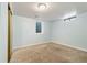 A bright basement bedroom with light blue walls, small windows, and a sliding door closet at 8137 Vanguard Dr, Denver, CO 80221