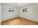 Bedroom featuring hardwood floors and two windows providing natural light at 8137 Vanguard Dr, Denver, CO 80221