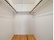 Walk-in closet featuring hardwood floors and hanging racks at 8137 Vanguard Dr, Denver, CO 80221
