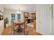 Cozy dining area with wood floors, table for four, and patio access to the yard at 8137 Vanguard Dr, Denver, CO 80221