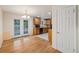 Eat in kitchen with black appliances, hardwood floors, and French doors to outdoor deck at 8137 Vanguard Dr, Denver, CO 80221