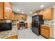 Updated kitchen featuring stainless steel appliances, granite countertops, and tile floors at 8137 Vanguard Dr, Denver, CO 80221