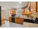 This updated kitchen features stainless appliances, granite counters, hardwood floors, and French doors at 8137 Vanguard Dr, Denver, CO 80221