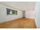 Inviting living room features hardwood floors, a large window, and neutral paint scheme at 8137 Vanguard Dr, Denver, CO 80221