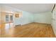 Bright living room featuring hardwood floors and an open layout to adjoining room at 8137 Vanguard Dr, Denver, CO 80221