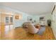 Bright living room with hardwood floors, neutral decor, and seamless access to the adjacent dining area at 8137 Vanguard Dr, Denver, CO 80221