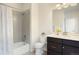 Well-lit bathroom featuring a shower-tub, a toilet, and a modern vanity with a large mirror and a plant at 524 E Hinsdale Ave, Littleton, CO 80122