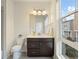 Modern bathroom with a large mirror, stylish vanity, and a window providing natural light and a view of the neighborhood at 524 E Hinsdale Ave, Littleton, CO 80122