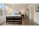 Inviting bedroom features a comfortable bed, bedside table and lamps, and a full-length mirror at 524 E Hinsdale Ave, Littleton, CO 80122