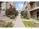 Landscaped walkway featuring well-maintained greenery, leading to inviting townhomes in a friendly community at 524 E Hinsdale Ave, Littleton, CO 80122