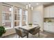 Dining area with modern lighting, windows, and a dining table with four upholstered chairs at 524 E Hinsdale Ave, Littleton, CO 80122