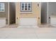 Attached two-car garage providing convenient parking and curb appeal with manicured landscaping at 524 E Hinsdale Ave, Littleton, CO 80122