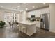 Open-concept kitchen featuring white cabinets, stainless appliances, and an island with seating at 524 E Hinsdale Ave, Littleton, CO 80122