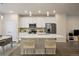 Modern kitchen with white cabinetry, stainless steel appliances, and a quartz island at 524 E Hinsdale Ave, Littleton, CO 80122