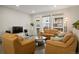 Comfortable living room with leather seating, large windows and an open doorway to the balcony at 524 E Hinsdale Ave, Littleton, CO 80122