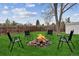 Relaxing backyard with a fire pit and four chairs creating an inviting outdoor entertainment space at 714 S Tabor St, Elizabeth, CO 80107