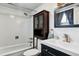 This bathroom features tiled walls, a shower head, and a built-in cabinet above the toilet at 714 S Tabor St, Elizabeth, CO 80107