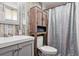 Charming bathroom with wood-look accent wall and built-in cabinet above toilet at 714 S Tabor St, Elizabeth, CO 80107