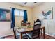 Cozy dining room features a wooden table, seating for four, bright sunflowers, and colorful wall art at 714 S Tabor St, Elizabeth, CO 80107