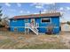 Charming blue two-story home with brown roof, white trim and welcoming front porch with white stairs at 714 S Tabor St, Elizabeth, CO 80107