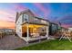 Outdoor patio with a grill, dining set, and string lights, ideal for entertaining in a spacious backyard at 502 Green Mountain Dr, Erie, CO 80516