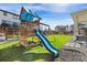 The backyard features a wooden playset with slide, swings and sandbox; great for to enjoy at 502 Green Mountain Dr, Erie, CO 80516