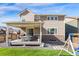 The backyard features a covered patio, gravel, and a playset on the lawn at 502 Green Mountain Dr, Erie, CO 80516