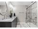 Modern bathroom with double sinks, granite counters, and marble shower with glass door at 502 Green Mountain Dr, Erie, CO 80516