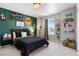 Charming bedroom featuring green accent wall, playful decor, carpet floors, and a bright window at 502 Green Mountain Dr, Erie, CO 80516