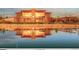 The community clubhouse reflected in a pond, featuring modern architecture and warm lighting at 502 Green Mountain Dr, Erie, CO 80516