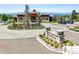 Front view of The Overlook clubhouse, featuring stone signage, desert landscaping, and an inviting entrance at 502 Green Mountain Dr, Erie, CO 80516