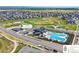 Community aerial view showing a modern clubhouse and swimming pool surrounded by Gathering friendly suburban homes at 502 Green Mountain Dr, Erie, CO 80516