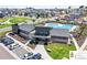 Aerial view of a community pool with modern clubhouse and plenty of parking surrounded by new homes at 502 Green Mountain Dr, Erie, CO 80516