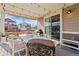 The covered patio features string lights, an outdoor grill, and a table perfect for relaxing at 502 Green Mountain Dr, Erie, CO 80516