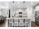 Contemporary kitchen featuring granite counters, stainless appliances, and a spacious island with barstool seating at 502 Green Mountain Dr, Erie, CO 80516
