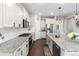 Well-equipped kitchen with granite countertops, white cabinets, and stainless steel appliances for culinary enthusiasts at 502 Green Mountain Dr, Erie, CO 80516