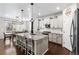Bright, modern kitchen with a large granite island, stainless steel appliances, and pendant lighting at 502 Green Mountain Dr, Erie, CO 80516