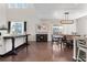 Open-concept living and dining area featuring hardwood floors, high ceilings, and ample natural light at 502 Green Mountain Dr, Erie, CO 80516
