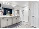 A main bathroom featuring double sinks, a large mirror, a glass shower, and white cabinets at 502 Green Mountain Dr, Erie, CO 80516